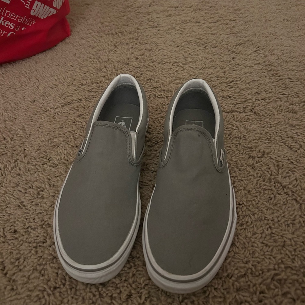 Grey and white slip on vans